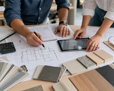 Clientes e engenheiro revisando planejamento e materiais da obra